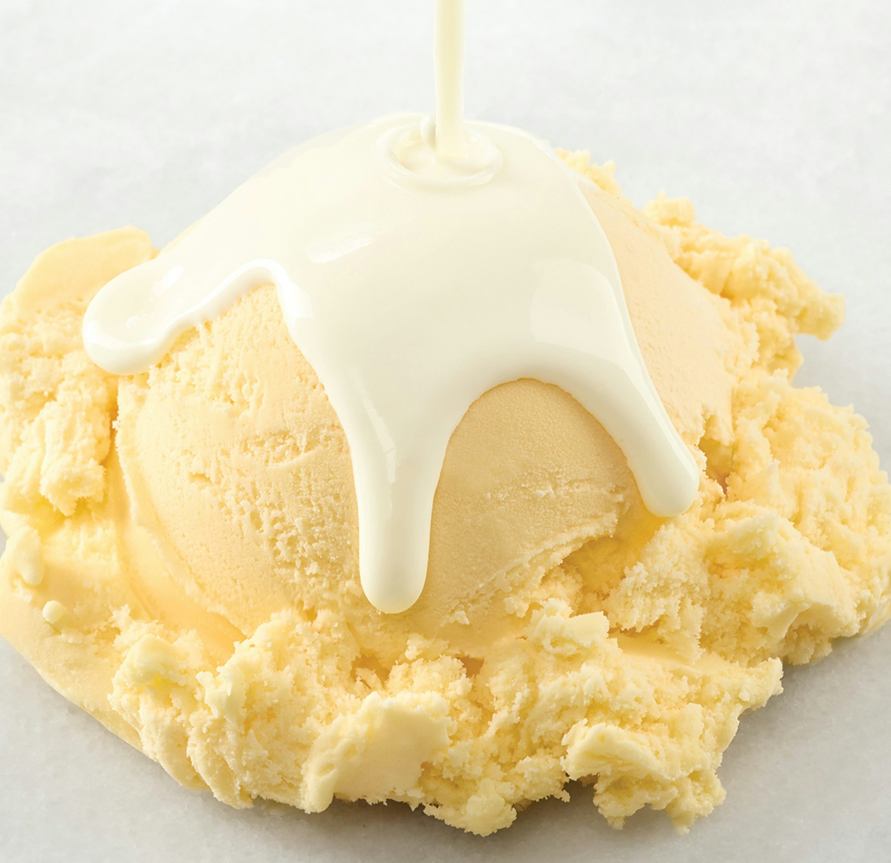 Ice cream being covered by fresh cream